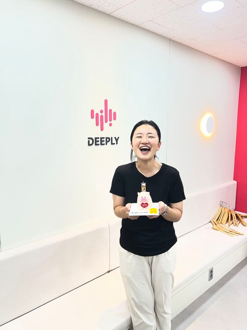Celebrating Deeply’s anniversary with a cake at the office